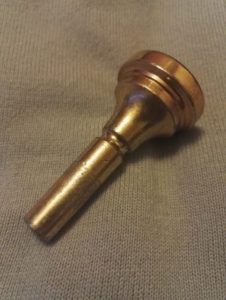 A trombone mouthpiece that needs cleaning