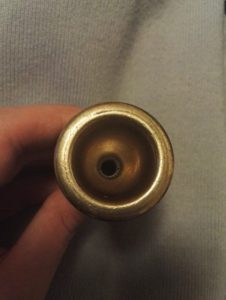 A trombone mouthpiece that needs cleaning